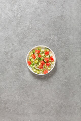 Salad of fresh vegetables and herbs with quinoa seeds and olive oil