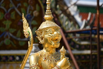 Golden Hanuman Statue From Ramayana In Close up Shot with blurry Background at the Wat Phra Kaew...