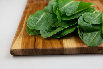 Roman lettuce on a wooden cutting board