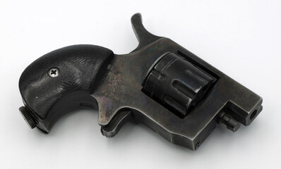 Black small pocket revolver on a white background
