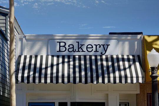 small town store front with striped awning and sign