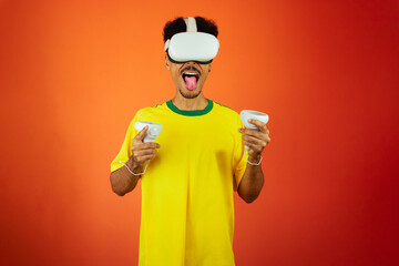 Brazilian Player - Black Man Celebrating With VR Virtual Glasses Isolated on Orange background