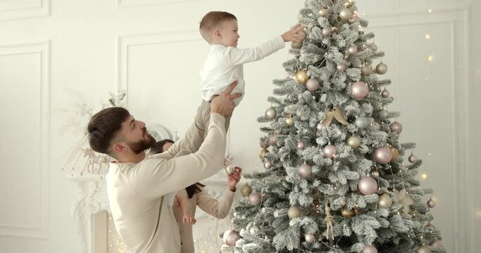 Happy family with kids decorating christmas tree