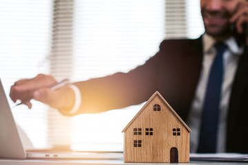 Real estate brokers talk on the phone to recommend investments to clients.