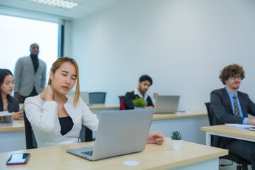 Exhausted Asian woman feeling sick, tired, exhuasted while working on table in office.