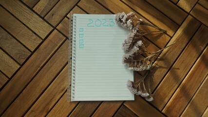 New year resolutions 2023 on desk - 2023 resolutions list with notebook - plan, action - checklist concept. New Year 2023 template - copy space