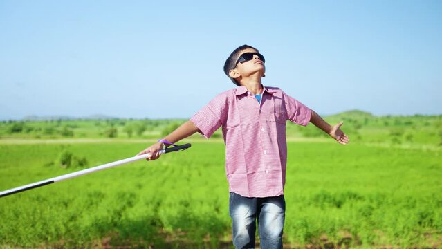 indian teeneger blind kid with eyeglasses enjoying nature and fresh air at freetime on mountain - concept of freedom, healthy lifestyle and wellness.