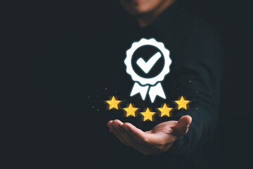 Businessman holding and showing the best quality assurance with golden stars. Quality control...