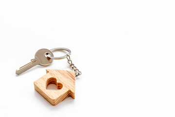 House shaped keychain and keys. Sale or rent real estate concept