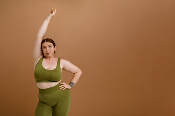 Young beautiful calm plus size girl with raised arm