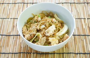 fried glass noodles slice pork and cabbage with egg on bowl