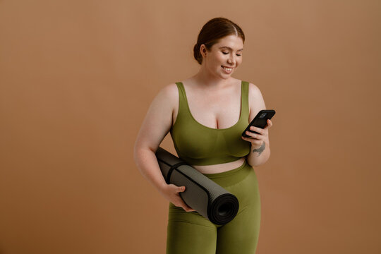 Young beautiful smiling plus size girl with phone