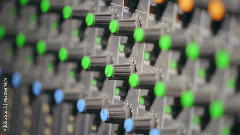 Poster close up isolated view of the dials and knobs in a professional recording studio