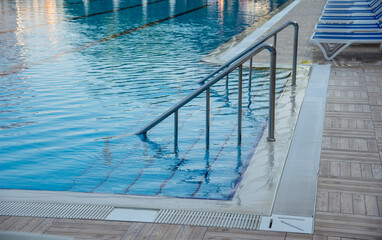 Stainless steel handrail and stairs into the swimming pool