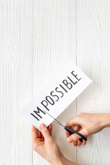 Paper card Impossible change into Possible with scissors