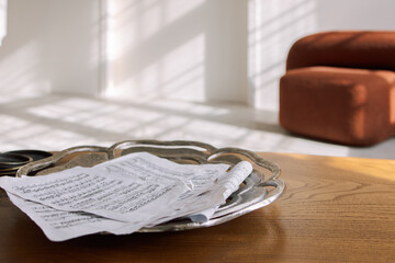 Modern room interior in minimal style. Music notes pages scattered on wooden table. Morning sun...