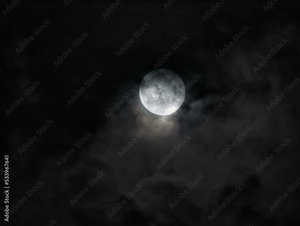 Wall mural full moon in partial cloud