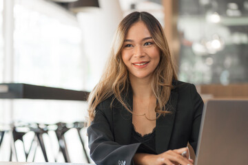 Confident asian businesswoman working  in office workstation.