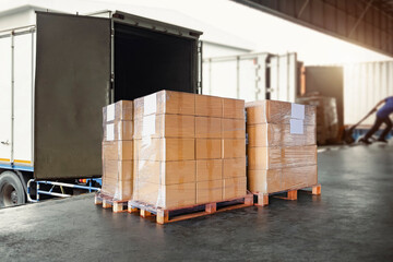 Packaging Boxes Wrapped Plastic Stacked on Pallets Loading into Cargo Container. Shipping Trucks. Supply Chain Shipment Boxes. Distribution Supplies Warehouse. Freight Truck Transport Logistics.	
