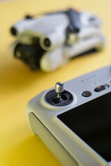 Detail of remote control of drone with drone in background