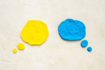 Commenication and messengers concept with text speech bubbles made of plasticine.