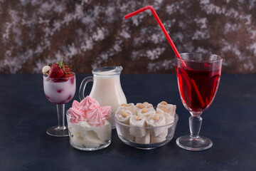 Dessert varieties with a glass of red wine on black background