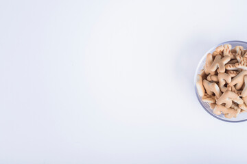 Vanilla crackers in letter shape in a glass cup on the right side