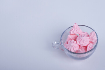 Pink flower shape marshmallows in a glass cup