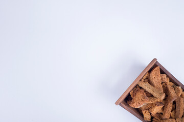 Bread crackers in a wooden tray in the bottom corner