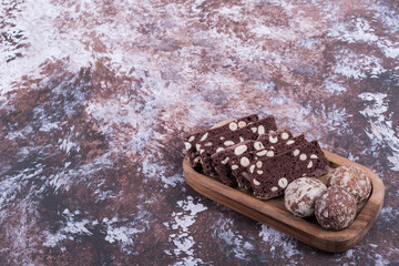 Cocoa cake slices and gingerbreads , angle view