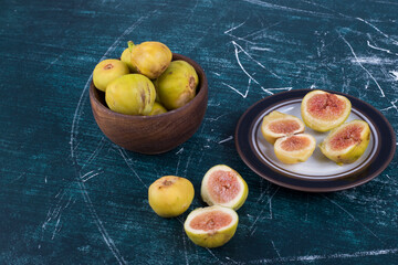 Whole and sliced figs in wooden dishes
