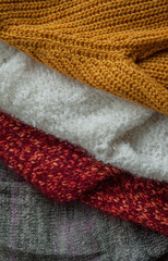 Autumn and winter background of knitted colourful sweaters