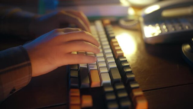 Closeup of male hands typing on retro keyboard, person working with computer