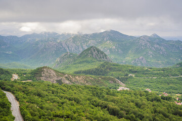 Beautiful view of the mountains of Montenegro and Skadar lake Portrait of a disgruntled girl sitting at a cafe table