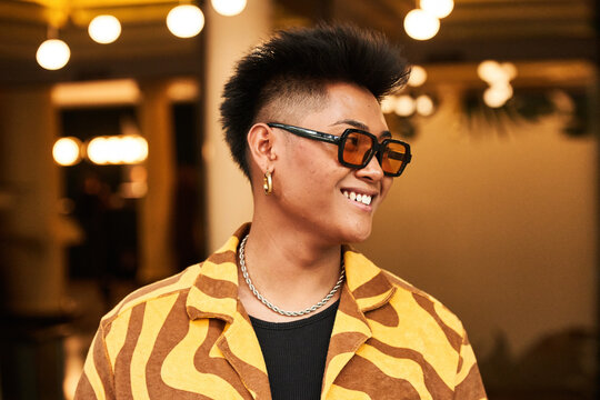 Cool happy Filipino male with skin acne looking away