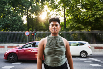 Non binary Filipino person looking at camera