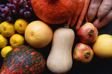 Various fresh and healthy autumnal fruit and vegetable. Top view, dark background.
