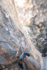 The sports girl is engaged in rock climbing