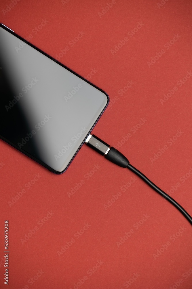 Poster phone with micro usb to usb type c adapter plugged in. phone usb adapter.