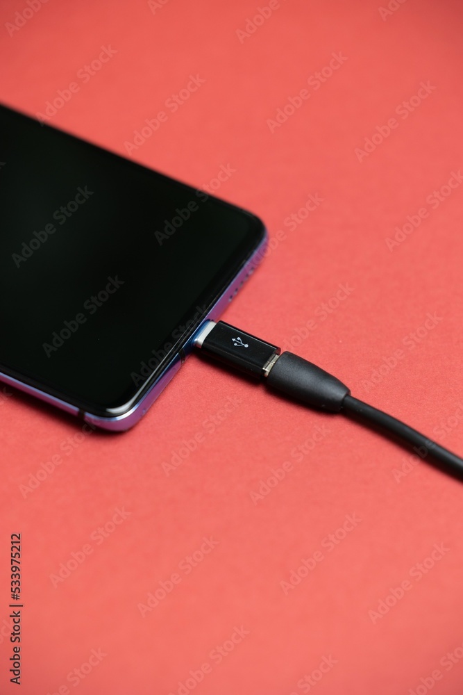 Poster phone with micro usb to usb type c adapter plugged in.