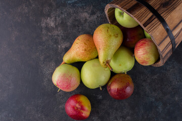 Apple, peach and pears out of a wooden bucket