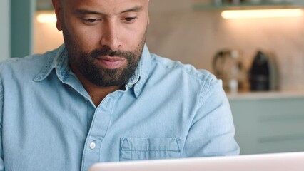 Man, laptop and working on web look at time on watch while thinking. Guy, computer and overtime work on internet, check clock in night do freelance, remote work or digital job online stay on schedule - Powered by Adobe