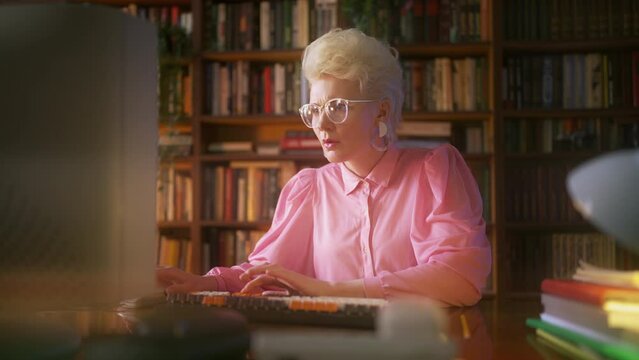 Young woman wearing vintage clothes and accessories working on computer, retro