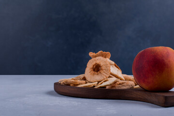 Peeled, sliced and dry apples with a peach