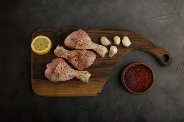 Raw chicken legs with garlic and spices