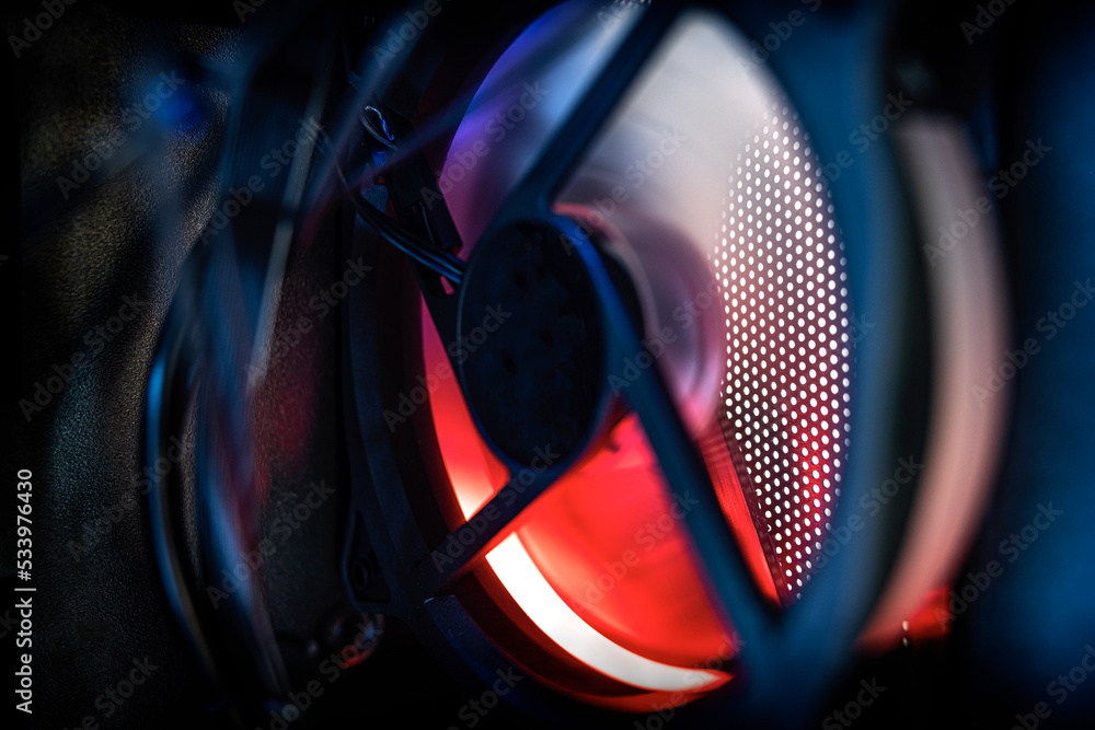 Poster glowing computer cooler while working close-up. inside the computer.