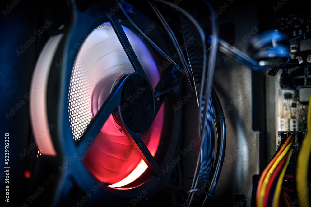 Poster glowing computer cooler while working close-up. inside the computer.