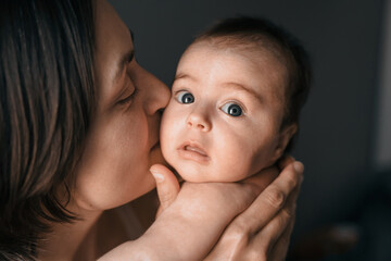 Mom, mummy, young mother with little baby daughter. Breast-feeding. Mum kissing,hugging child. Newborn cute happy girl smiling in woman hands. Family happiness. Age parents, parenting, motherhood