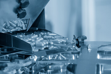 Close-up scene of the piles of capsules pill in the production line.