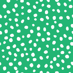 Abstract seamless pattern of hand-drawn white dots-specks on a green background. Different sizes and shapes of white spots (polka dots) on a green background -perfect seamless pattern
